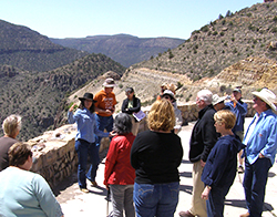 Tour Leader talking to tour guests in a barren, mountainous landscape