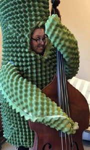 Syndenn dressed as a saguaro with a double bass.