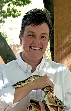 Hollie Colahan holds a ball python in her hands